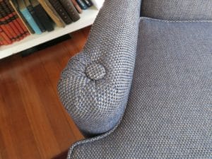 Wing chair arm finished with a button on top | Upholstered in a Greenhouse Fabrics | Upholstered by Cape Cod Upholstery Shop | Located in South Dennis, MA