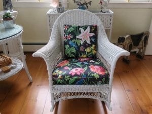 Antique Wicker Rocking Chair | Upholstered in a Schumacher Chintz Floral Print | Upholstered by Cape Cod Upholstery Shop | Located in South Dennis, MA