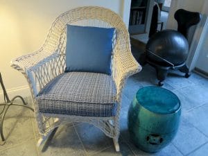 White wicker rocker with removable seat cushion and back pillow | Upholstered in a Stout Fabrics and Greenhouse Fabrics stripe and solid | Upholstered by Cape Cod Upholstery Shop | Located in South Dennis, MA 02660