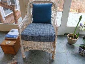 White wicker chair with removable seat cushion and back pillow | Upholstered in a Stout Fabrics and Greenhouse Fabrics stripe and solid | Upholstered by Cape Cod Upholstery Shop | Located in South Dennis, MA 02660