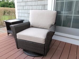 Brown Outdoor Wicker Swivel Chair | Cushions upholstered in Sunbrella Blend-Sand | Upholstered by Cape Cod Upholstery Shop | Located in South Dennis, MA 02660