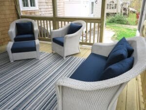 Lloyd Flanders white outdoor wicker chairs, ottoman and love seat | Cushions upholstered with Sunbrella Spectrum Indigo outdoor fabric | EZ-Dri foam inserts | Upholstered by Cape Cod Upholstery Shop | Located in South Dennis, MA 02660