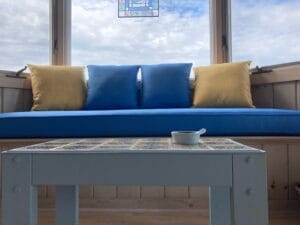 85" window seat with four 18" square throw pillows | Cushion covers upholstered with JF & Greenhouse Fabrics | Upholstered by Cape Cod Upholstery Shop | Located in South Dennis, MA 02660