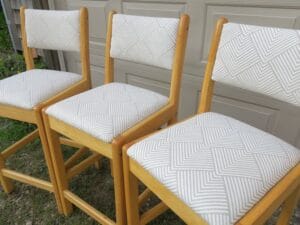 Side view of matching wood bar stools | Upholstered in a geometric pattern fabric | Upholstered by Cape Cod Upholstery Shop | Located in South Dennis, MA 02660