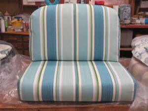 Seat and back cushions upholstered in an bight outdoor stripe | Upholstered by Cape Cod Upholstery Shop | Located in South Dennis, MA 02660
