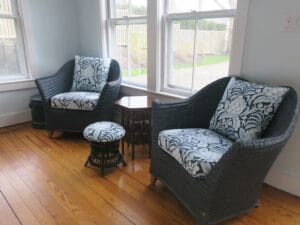 Low back wicker chairs painted Blue with seat cushion and loose pillow back | Upholstered with a Perennials high performance fabric | Upholstered by Cape Cod Upholstery Shop located in South Dennis, MA 02660