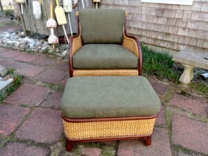Cane chair and matching ottoman with mahogany wood trim | Loose seat and back cushions upholstered in a Greenhouse Fabrics solid dark green chenille | Upholstered by Cape Cod Upholstery Shop | Located in South Dennis, MA 02660