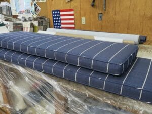 Two boxed style self welted cushions with a blue background and thin white stripe. Welting cord is cut on the bias. Cushions fabricated by Cape Cod Upholstery Shop | Located in South Dennis, MA 02660