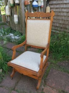 Antique Platform Rocker. Upholstered in a neutral color tweed polyester fabric with double welting trim. Upholstered by Cape Cod Upholstery Shop | Located in South Dennis, MA 02660