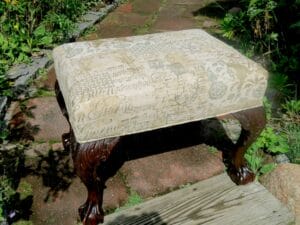 Antique Victorian Footstool. Upholstered in a musical themed linen fabric. Upholstered by Cape Cod Upholstery Shop | Located in South Dennis, MA 02660