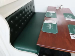 Clancy's Restaurant in South Dennis, MA 62" upholstered booth seat. Upholstered with a Greenhouse Fabrics commercial grade green vinyl material. Upholstered by Cape Cod Upholstery Shop | Located in South Dennis, MA 02660
