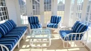 Rattan chairs and sofa. Sunbrella Milano Cobalt. Three season room with white rattan chairs and sofa. Cushions fabricated with Sunbrella Milano Cobalt. All new CertiPur-US upholstery foam. Cushions fabricated by Cape Cod Upholstery Shop - South Dennis, MA 02660